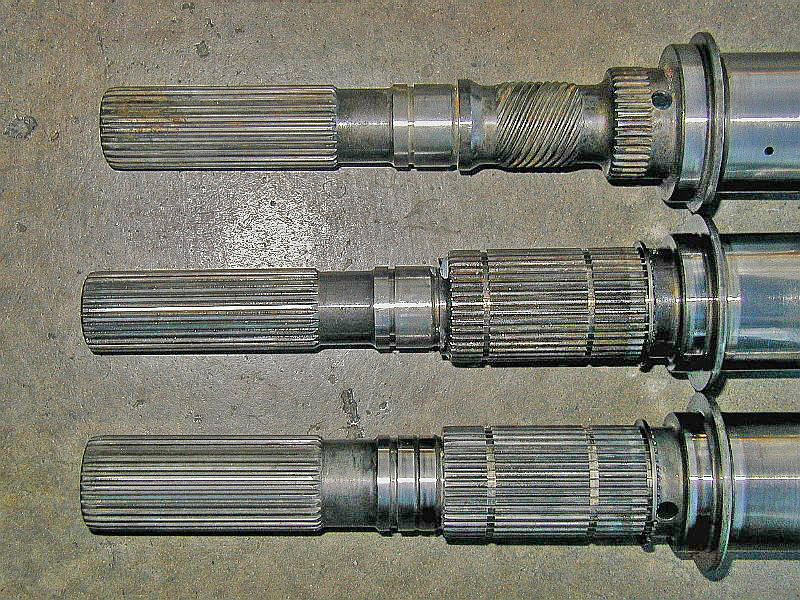 Closeup of the rear and of several mainshafts. The top one is a 242 Jeep. The middle is a 93-94 AMG. The bottom is a 96 up AMG. Note the top two have a 27 spline output and the bottom one is a 32 spline output.