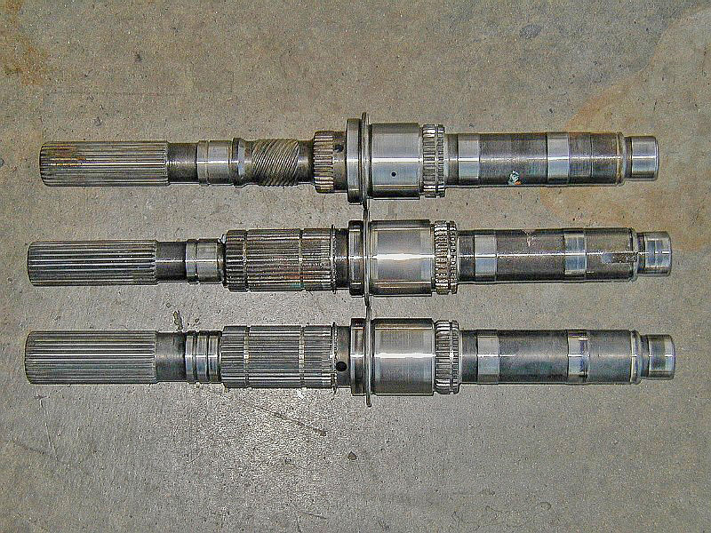 The rear and of several mainshafts. The top one is a 242 Jeep. The middle is a 93-94 AMG. The bottom is a 96 up AMG. Note the top two have a 27 spline output and the bottom one is a 32 spline output.