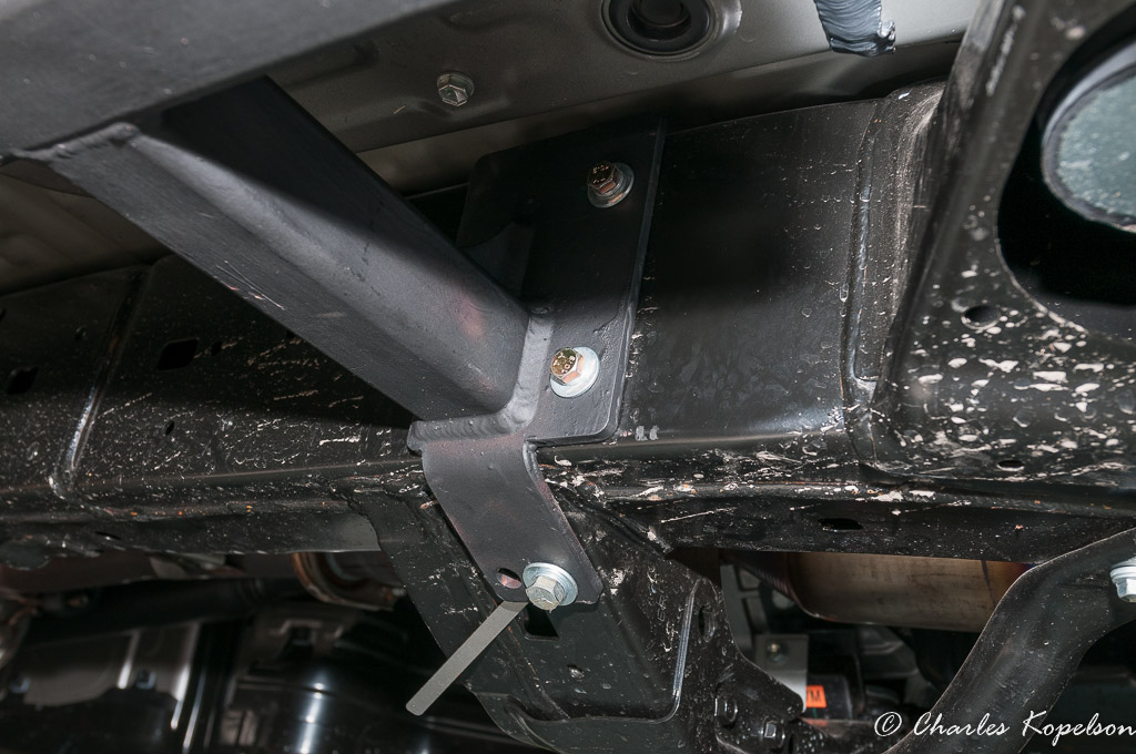 Bolt the front mounting plate to the transmission cross member and the frame using the stick nuts if needed.
