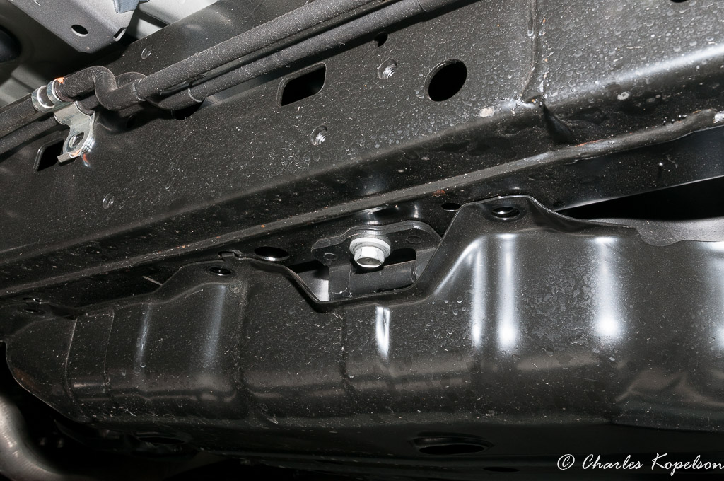 Remove all the gas tank skid bolts and the gas tank strap bolt (shown). I supported the gas tank with a small floor jack.