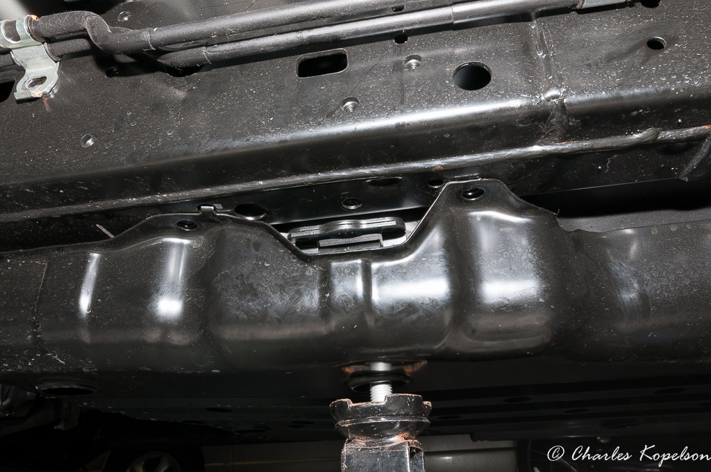 Remove all the gas tank skid bolts and the gas tank strap bolt. I supported the gas tank with a small floor jack.
