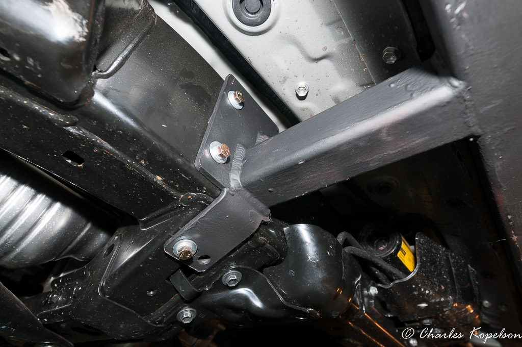 The 2 top bolts thread into the frame. Drill a hole in the cross member for the bottom bolt and secure with a stick nut.