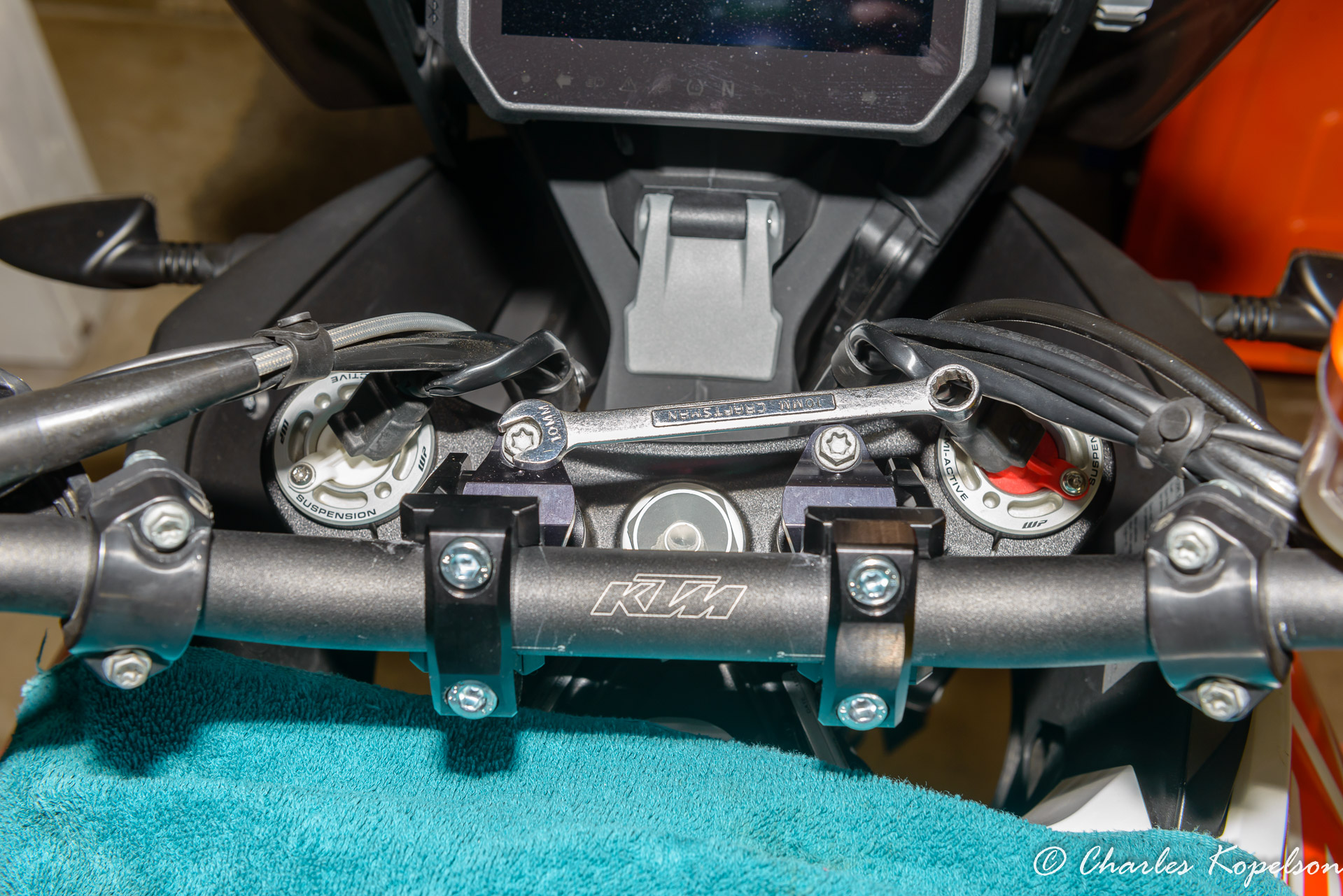 In my case I wanted more pullback than rise so I rotated the risers toward the rider.  You can tighten the riser clamps with a #40 Torx or a 10mm wrench.