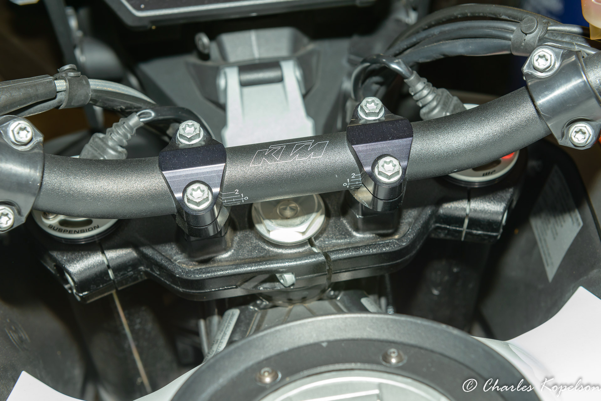 This is a tapered handlebar. It's 1-1/8 in  the center and  7/8 at the ends.  The bar isn't centered.  Look at the 3rd row of horizontal white lines on the bar. They are not equal length.