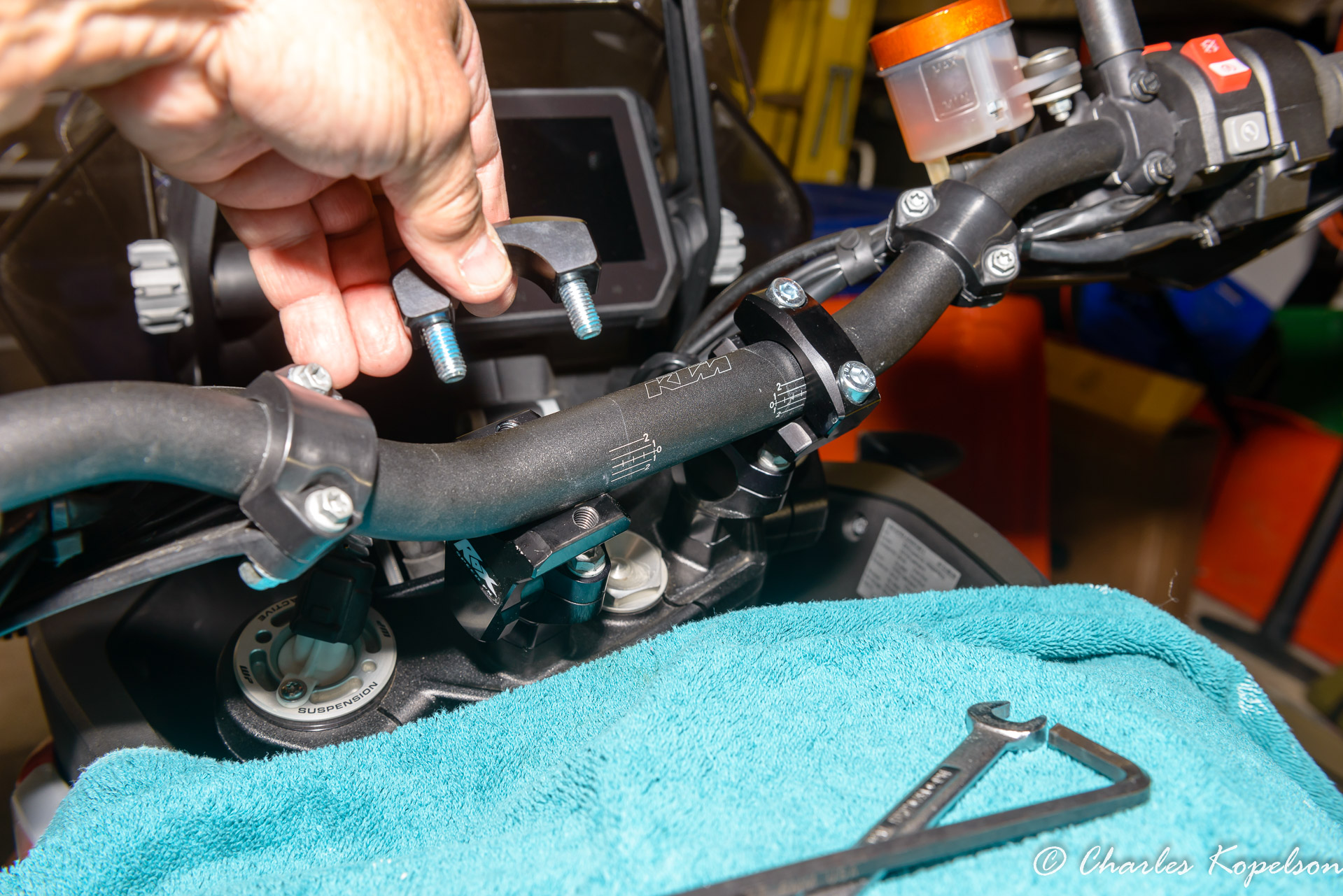 Set the handlebar down into the new risers and center it.  Place the top of the ROX clamps over the handlebar and lightly tighten with a 6mm hex wrench.