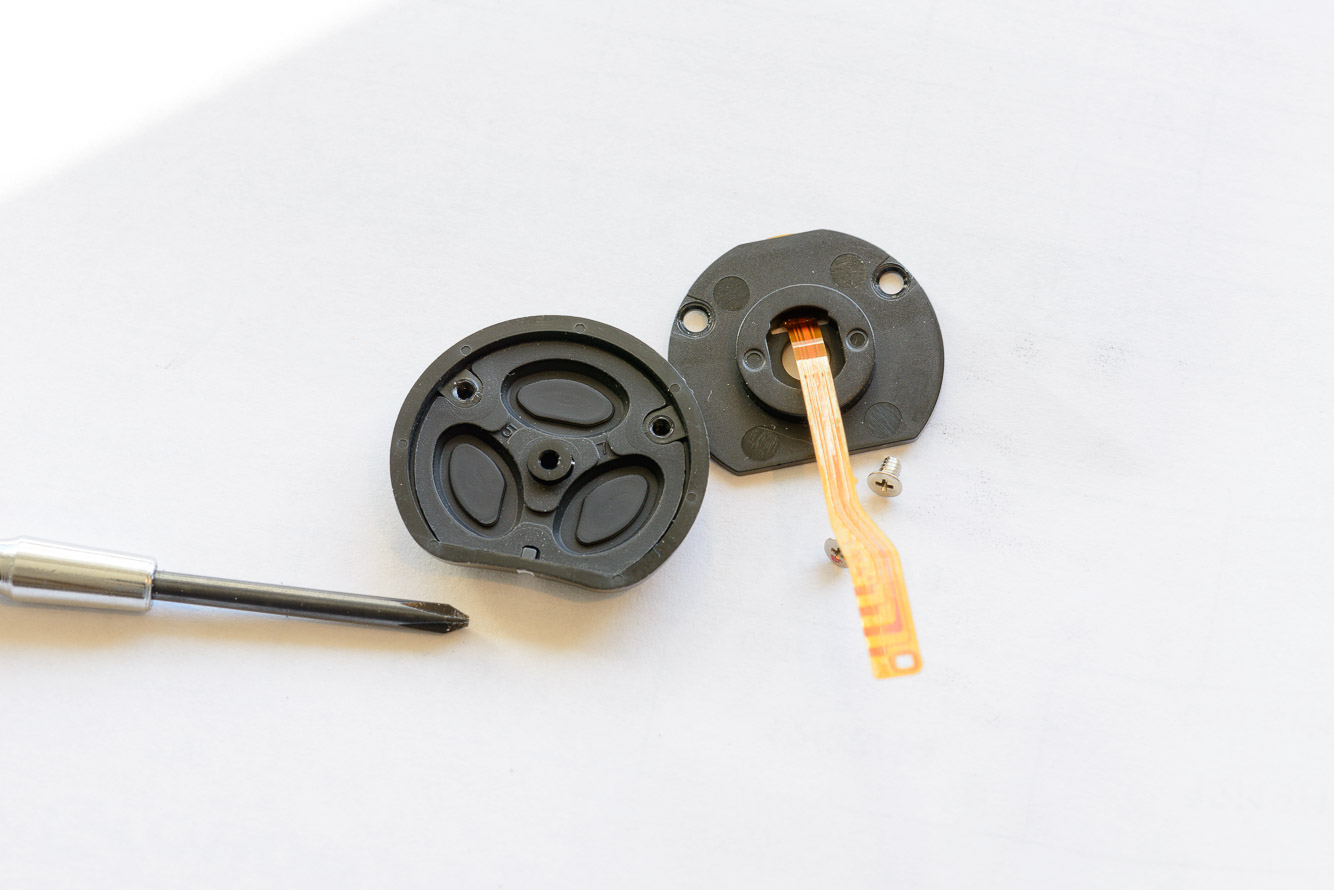 Remove the button cap from the button contact board.