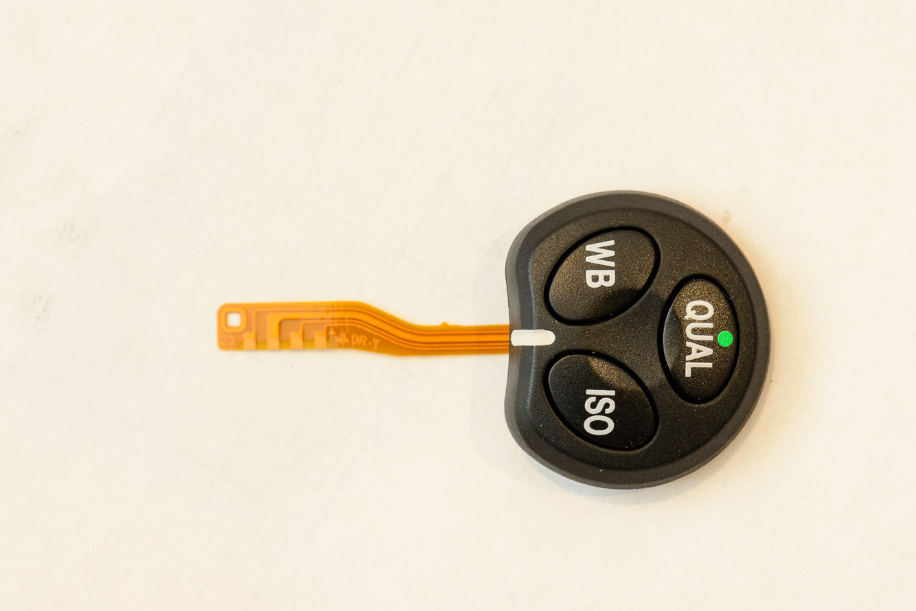 I bought a new QUAL WB ISO Button for 29.00 from an ebay seller in China because Nikon won't sell you parts.