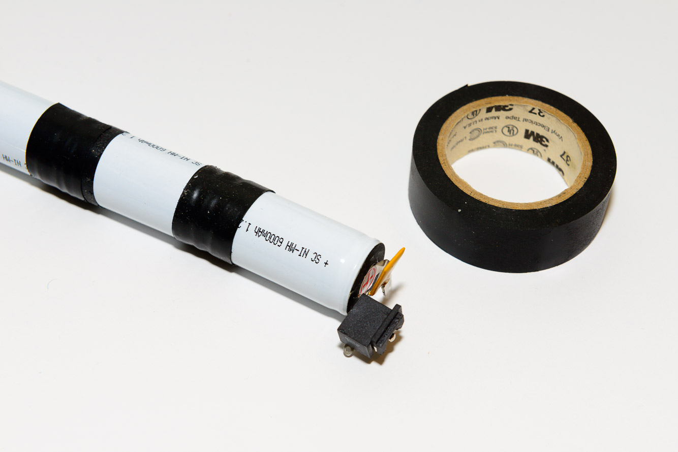 Tape the 2 sets of 3 cells together with electrical tape.