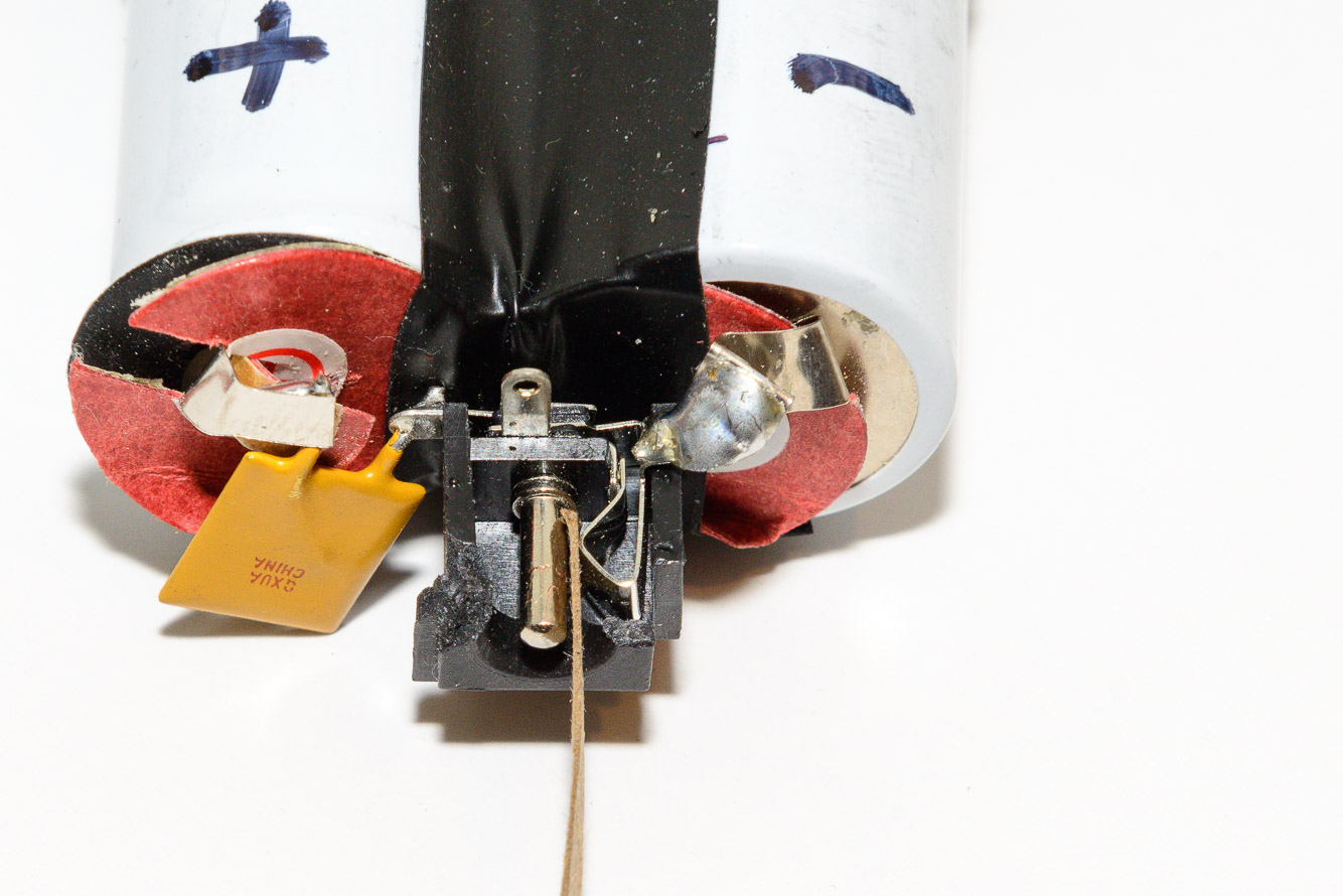 You can see how the center post and the ground in the socket were touching where the strip of cardboard is.  Once the batteries were put back in the case and the socket was aligned with the other half there was no problem.