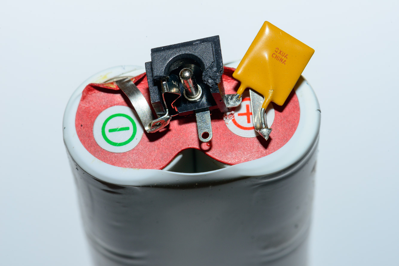 The detail of the socket and wiring.  I think the yellow part is a thermistor which shuts off the current if the batteries get too hot.
